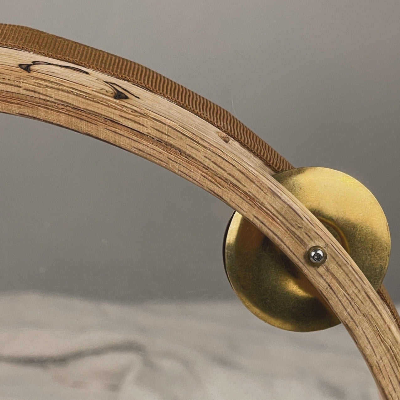 Close-up of Cerro tamburello’s interchangeable brass jingles mounted on a 5 cm oak frame