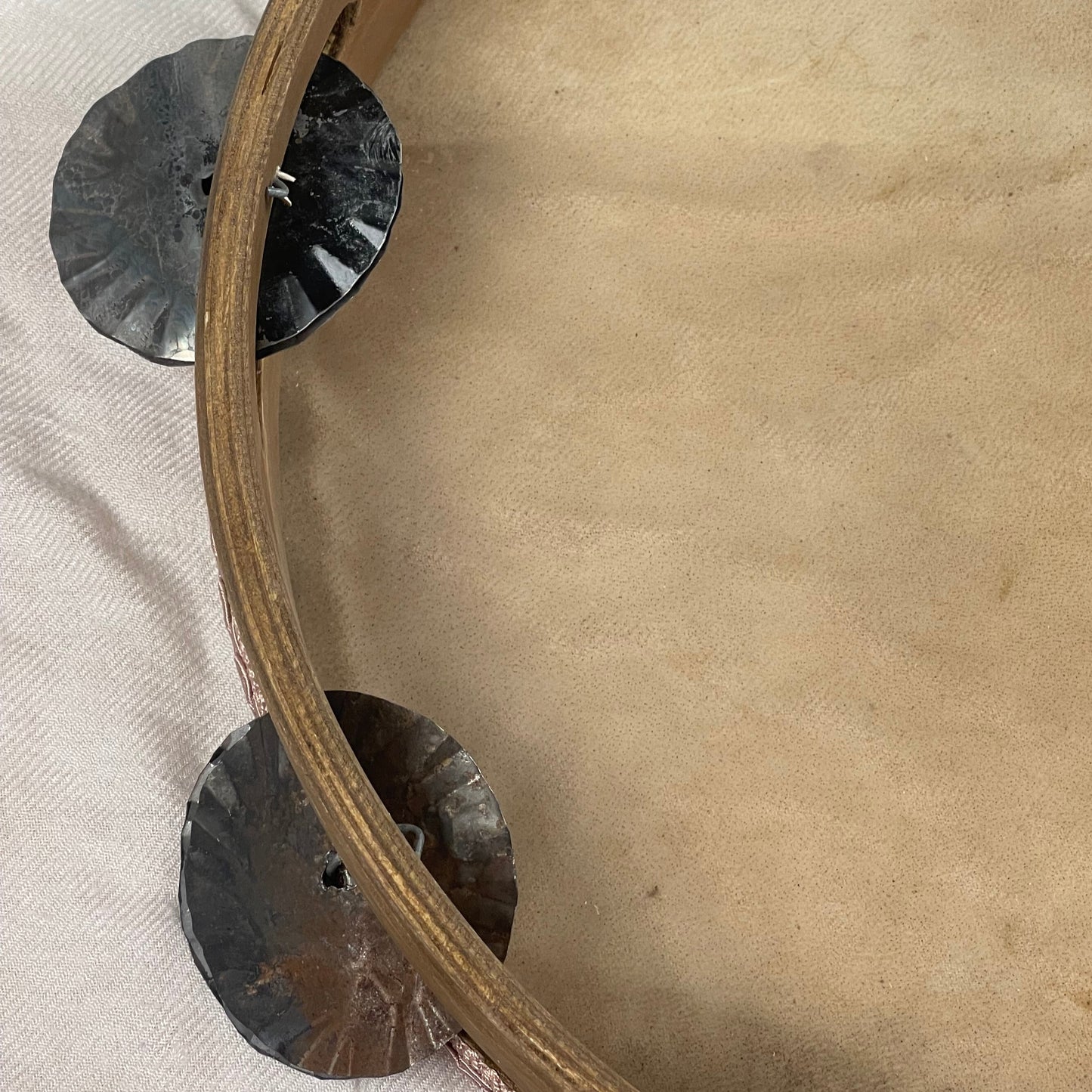 Detail of hand-hammered and roasted tin jingles