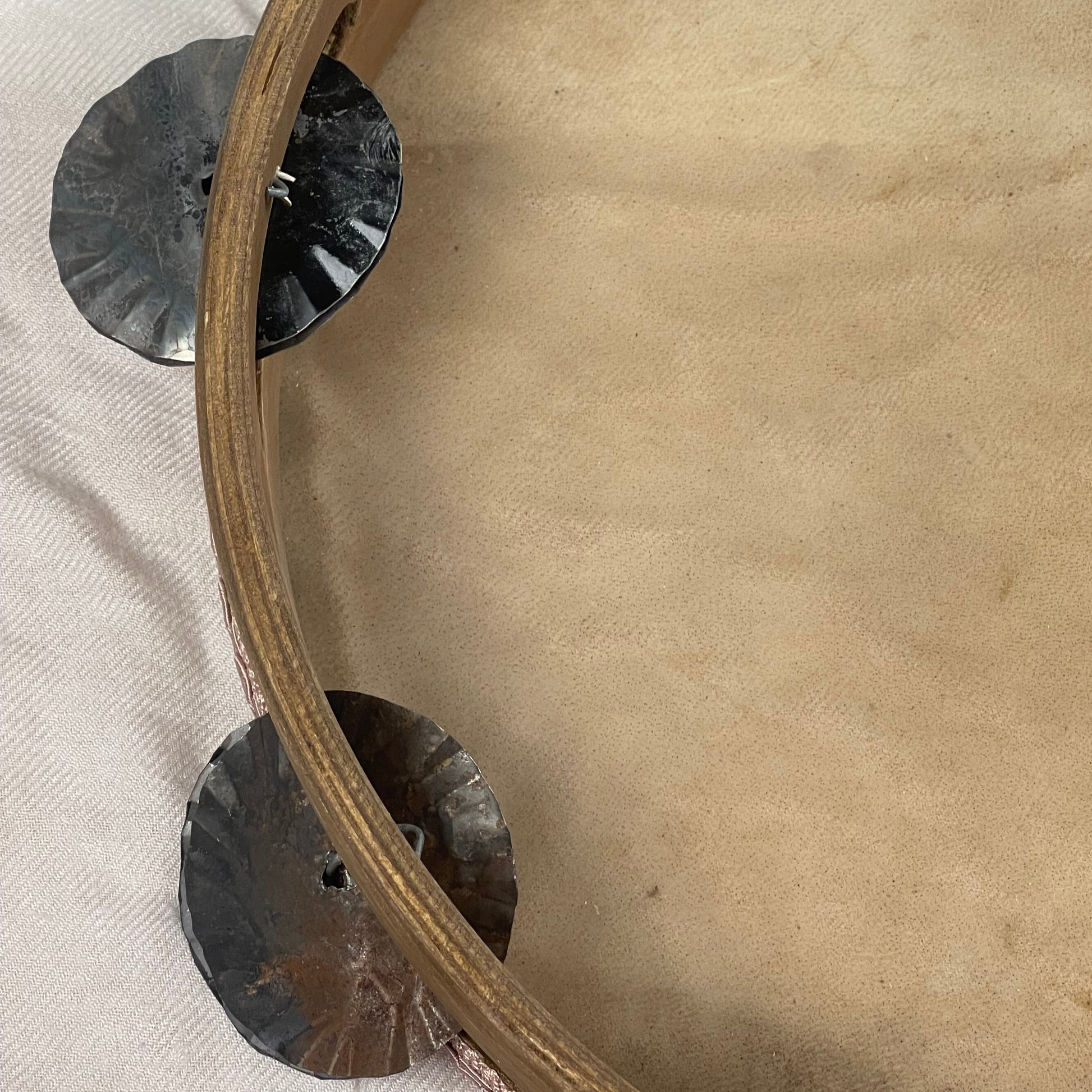 Detail of hand-hammered and roasted tin jingles