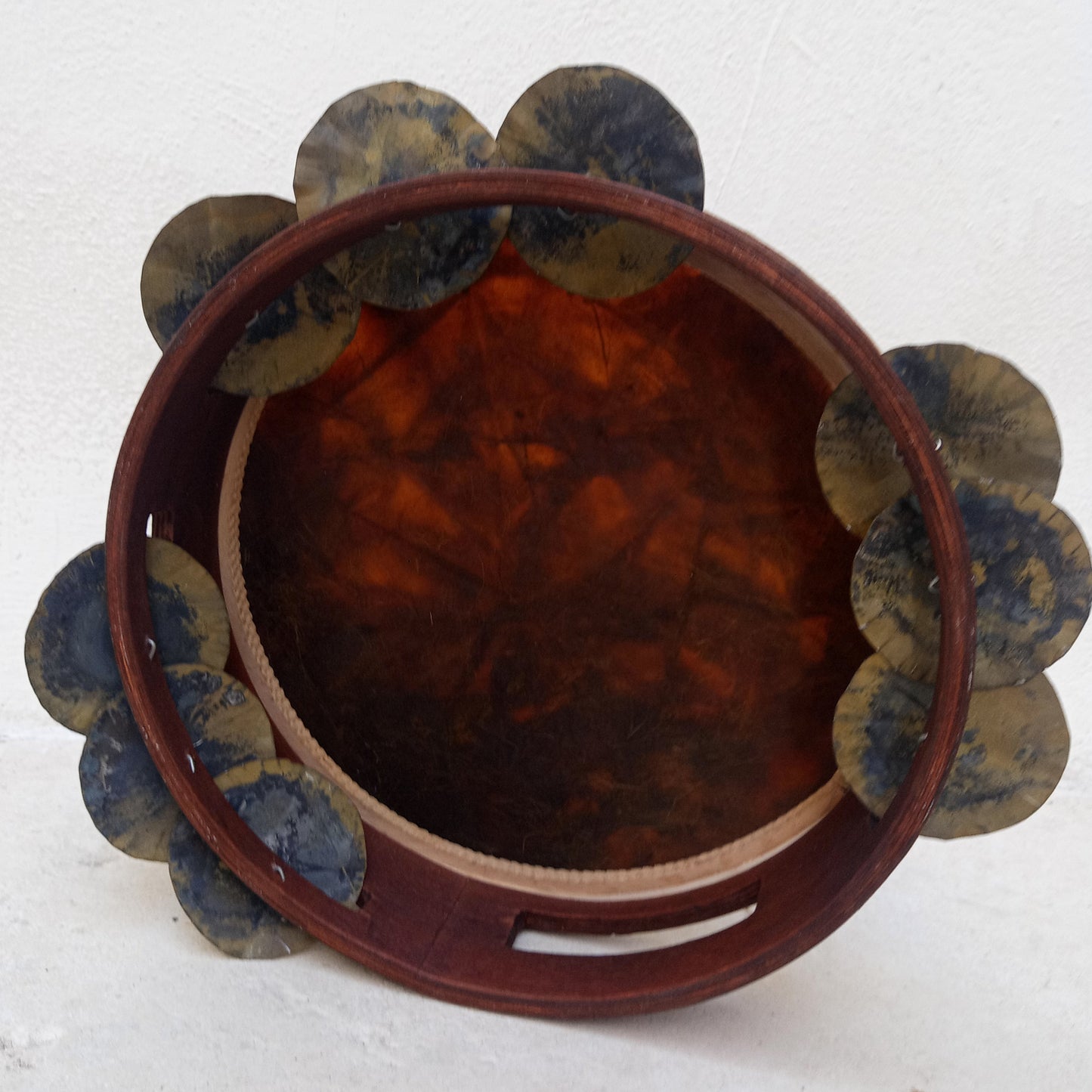 Handmade traditional tambourine with hammered tin jingles