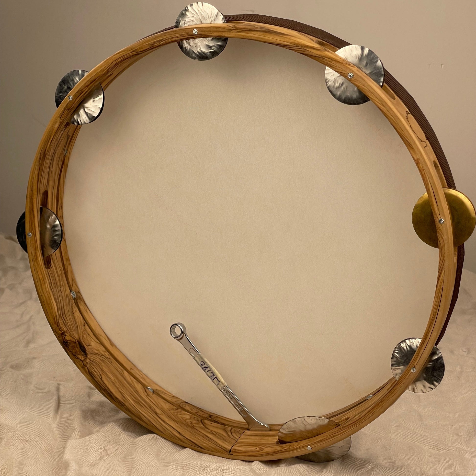 Hex-nut tuning system on olive wood tambourine with tuning key