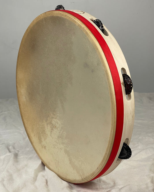 Traditional tambourine with goat skin head and beer cap jingles