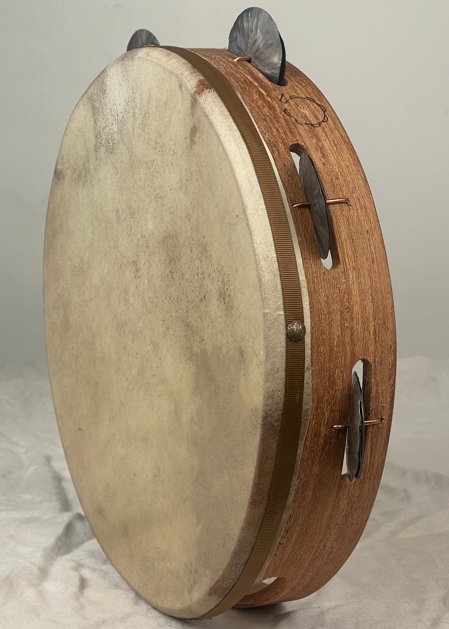 Side view showing 7 pairs of tin jingles