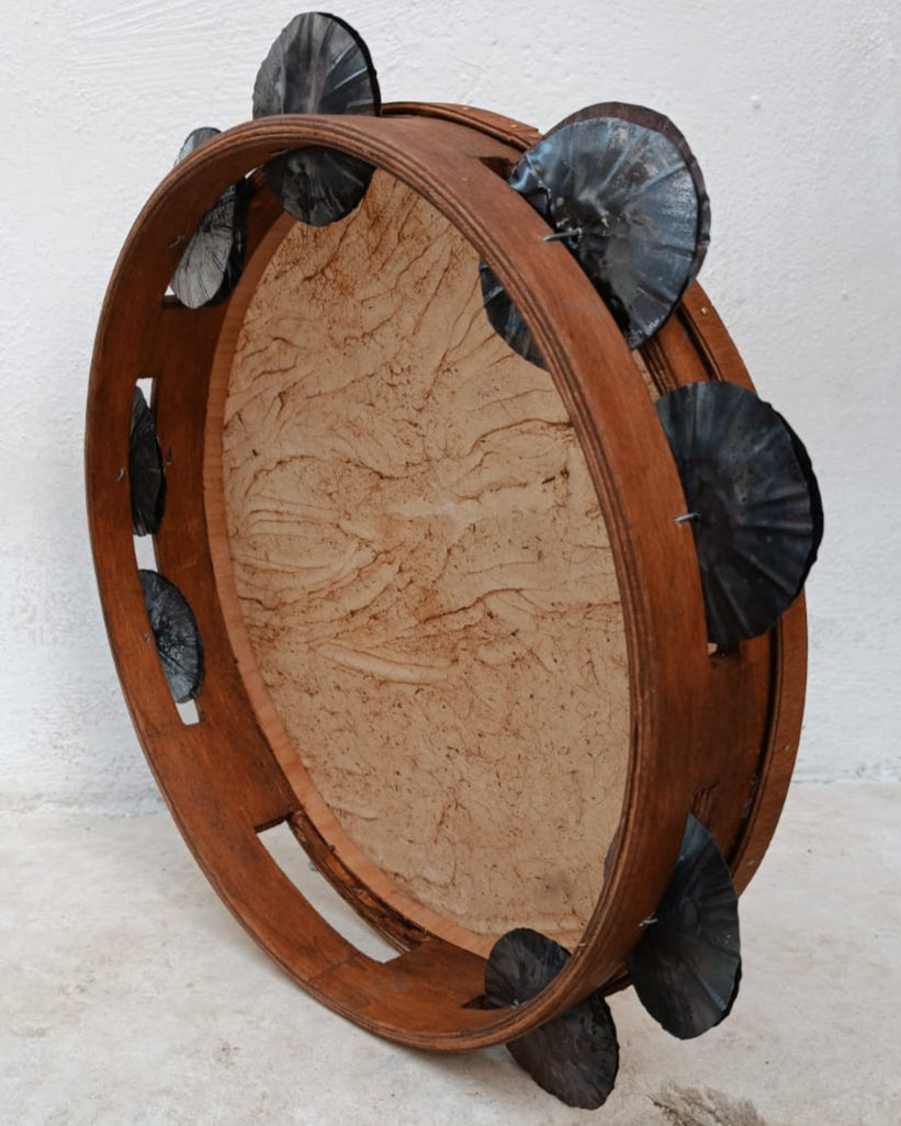 Window-handle detail on handmade folk tambourine